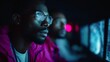 © Olly Photography - A dedicated man with glasses intently analyzing code on a screen, exemplifying a modern cybersecurity or programming professional environment.