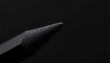 © anulak - A pencil s lead tip, focused and precise, with a slight tremor suggesting dedication to detail. Extreme close up macro shot of the sharpened graphite tip of a wooden pencil. The tip is perfectly