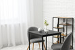 © Pixel-Shot - Interior of dining room with table, chairs and shelving unit near white brick wall