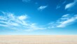© Studicon - Vast expanse of pale sand under a vibrant blue sky with wispy clouds