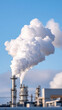 © praewpailyn - White smoke billowing from industrial chimneys against clear blue sky showing rare earth elements mining impact on environment and air quality