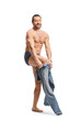 © Ljupco Smokovski - Naked man in underwear putting on a pair of jeans and smiling