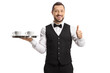 © Ljupco Smokovski - Server holding a tray with coffee cups and showing thumbs up