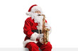 © Ljupco Smokovski - Santa Claus playing sax and sitting on a wall