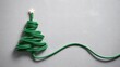 © Mehjabin - Creative Christmas tree made from green electric cable with star shining brightly, perfect for modern holiday greetings and eco-friendly marketing campaigns
