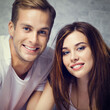 © vgstudio - Love, dating, lovers, romantic concept - portrait of happy smiling cute young couple, man woman, boyfriend girlfriend pose against home wall background. Dental care. Square image