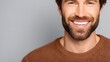 © AI Background  - Smiling man with short hair and beard wearing a brown sweater against a light gray background, expressing joy and confidence