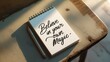 © Bright - Notepad with inspirational quote believe in your own magic on wooden table