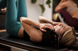 © Nikola Spasenoski - Engaging in reformer pilates workout for strength and flexibility in a modern fitness studio during the morning session