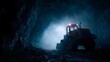 © Bussakon - A heavy industrial loader operates within a dark dusty and atmospheric underground mining tunnel illuminated by its own lights