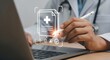 © Shabbir - Doctor using digital pen on laptop to access patient records, offering modern healthcare solutions with seamless electronic medical data management and efficiency