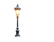 © Falconn Std - Ornate black vintage lamppost with a warm glowing light isolated on white.