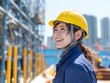 © Jumpei - 建設現場でヘルメットを着用し笑顔を見せる若い女性作業員と安全意識のイメージ
