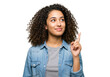 © AnaMaria - Smiling young woman with curly hair pointing up isolated PNG, concept of idea or solution on transparent background