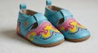 © Senin - Pair of turquoise leather baby shoes with pink and yellow decorative elements