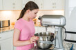 © arinahabich - Girl Pours Nuts into Mixing Bowl