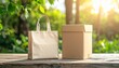 © andre - Eco-friendly paper bag and cardboard box on a rustic wooden table with a blurred natural green background during golden hour