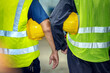© BESTIMAGE - Two construction workers wearing yellow hard hats and green reflective vests