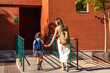 © unai - Mother and daughter holding hands walking to school