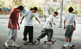 Group of young skaters riding together in an urban plaza