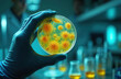 © miss irine - Gloved hand holds petri dish with yellow bacteria colonies. Scientists work in modern lab with tubes and equipment. Researching microbes for medical or scientific discovery.