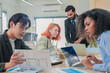 © whyframeshot - group of multicultural male and female professionals meet inside a contemporary office, leveraging artificial intelligence and big data analytics to brainstorm, exchange ideas, and build adaptive