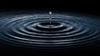 © Stock by Anindya - Water drop creating ripples in a dark pool of water with a black background.