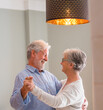 © Daniel - Joyful active old retired romantic couple dancing laughing in living room, happy middle aged wife and elder husband having fun at home, smiling senior family grandparents relaxing bonding together