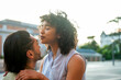 © GREGORIO - Interracial couple sharing an intimate moment outdoors