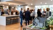 © pvl0707 - Real estate networking event showcasing a miniature model house in a modern interior setting with professionals discussing opportunities