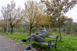 © Daanree - Man resting alone on a bench in a park during autumn, surrounded by colorful trees and fallen leaves, symbolizing peace, solitude, and reflection in a calm natural environment.