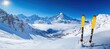 © Ulyana - Bright sunny winter mountain landscape with snow-covered peaks and two yellow skis standing upright in fresh snow