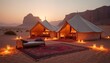 © Maryna - Desert glamping campsite with two luxury tents illuminated at sunset. Romantic camping experience offers comfort. Adventure travel concept in remote area. Nomad lifestyle. Dune landscape.
