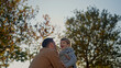 © Creative Light - Father and son laughing together in a park on a sunny autumn day