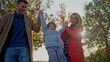 © Creative Light - Happy family playing outdoors, swinging their son in the air on a sunny day