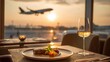 © Babb - A plate of food is on a table with a glass of wine. The table is near an airport and a plane is flying in the background. Concept of relaxation and leisure