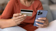 © fizkes - Female bank client making financial transaction on Internet application