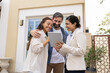 © fizkes - Smiling realtor with tablet show customers property information on screen
