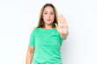 © luismolinero - Young caucasian woman isolated on white background making stop gesture