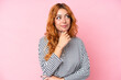 © luismolinero - Young caucasian woman isolated on pink background and looking up