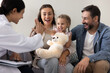 © fizkes - Joyful little girl giving high five to smiling female doctor