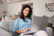 © fizkes - Happy young Latin freelance professional woman working from home