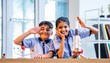 © StockImageFactory - Indian students explore space rocket model in classroom while learning aerospace concepts in uniform