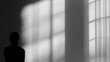 © Vitalii - Black and white photograph of a person standing in front of a large window. the person is facing away from the camera, with their back to the viewer.