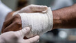 © MONWARA - Close-Up of Doctor Bandaging Injured Hand with Medical Care and Support