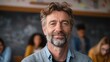 © Johannes - portrait of mature teacher looking at camera with copy space happy mid adult lecturer at classroom standing after giving lecture satisfied high school teacher smiling while his students studying no l