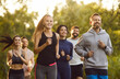 © Studio Romantic - Team of cheerful active young people in sportswear running together in park, having training in nature, enjoying fresh air outdoors, promoting physical fitness, leading healthy lifestyle.