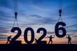 © Ольга Клецкова - Construction workers building 2026 digits at sunset for New Year celebration in real estate. architecture industry greeting banner