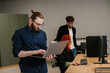 © dsheremeta - Business colleagues collaborating and working in modern office