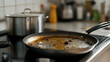 © A2Z AI  - A used frying pan rests on a black stovetop in a bright kitchen. A large pot sits behind it. The pan shows cooked food remnants. Home cooking mess, and meal prep are shown.